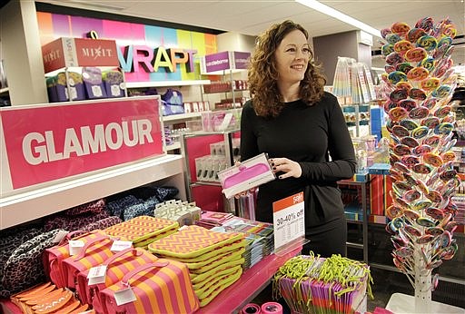 In this Oct. 27, 2011 photo, Lorraine Hitch, senior vice president of J.C. Penney, talks about items in the Glamour display, in New York. As consumers go, so goes the economy. Consumer spending accounts for 70 percent of economic activity, so a strong shopping season could be just the boost the economy needs. 