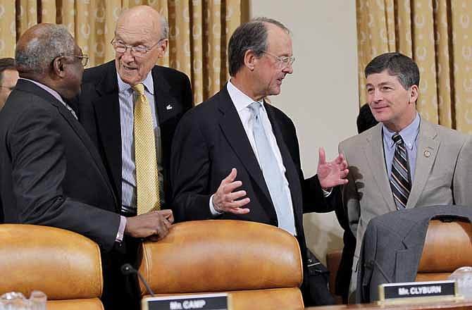 Supercommittee Co-Chair Rep. Jeb Hensarling, R-Texas, right, and Supercommittee member Rep. James Clyburn, D-S.C., left, welcome Erskine Bowles, second from right and former Wyoming Sen. Alan Simpson, second from left, on Capitol Hill in Washington, Tuesday, Nov. 1, 2011, prior to the Supercommittee's hearing where Bowles and Simpson testified.