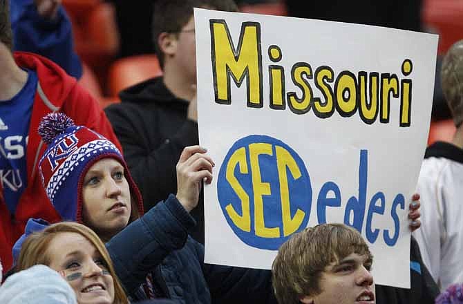 An unidentified Kansas fan holds up a sign during the first half of an NCAA college football game against Missouri at Arrowhead Stadium in Kansas City, Mo., Saturday, Nov. 26, 2011. Missouri is leaving the Big 12 conference for the SEC. 