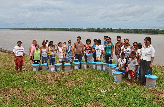 Peruvian church members are shown receiving their water bucket filtration systems along the Amazon River during a First Presbyterian mission last summer.