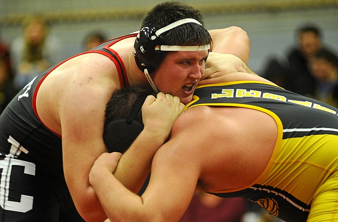 John Carter of Jefferson City locks up with Andrew Horsley of Lebanon during their 285-pound match Tuesday night at Fleming Fieldhouse.