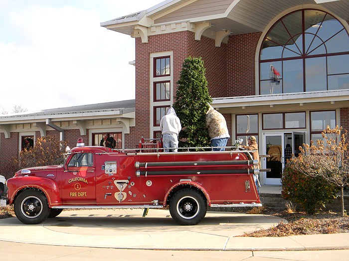 City of California workers decorate a tree placed on a California Fire Department firetruck at City Hall Tuesday, Nov. 29.