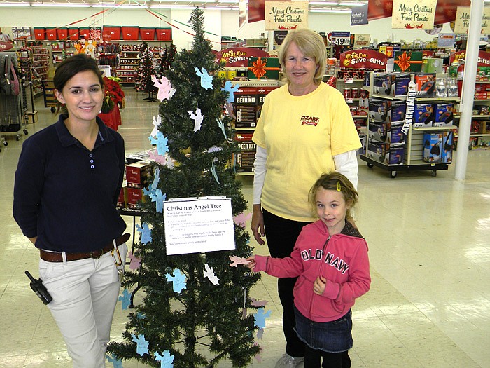 California Pamida Operations Team Leader Leigha McClelland. left, with Angel Tree Program Chairman Judy Scott, right, and Jada Graham, middle, holding an angel from the Angel Tree located inside the California Pamida.