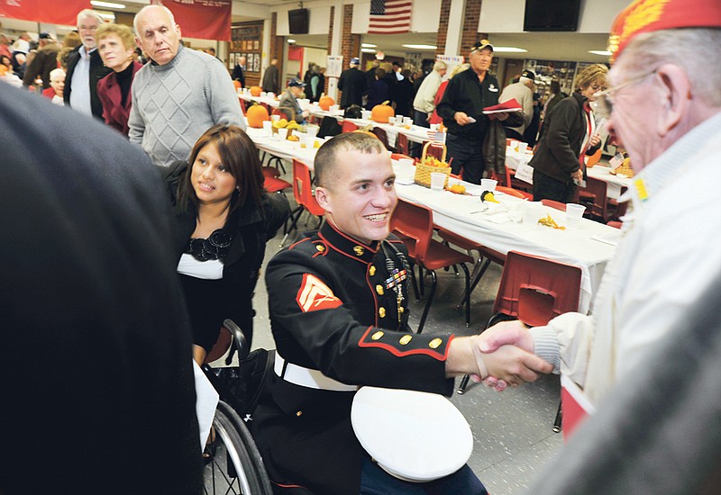 Lance Cpl. Tyler Huffman, center, greets well-wishers at the Jefferson City High School's Ambassador Club's Veteran's Appreciation Night on Nov. 10 where he was the guest of honor. Huffman will be the parade marshal for both the Fulton and Holts Summit Christmas parades. 