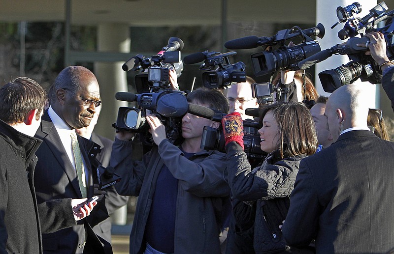 Republican presidential candidate Herman Cain leaves the Manchester Union Leader newspaper after meeting with the editorial board Thursday.