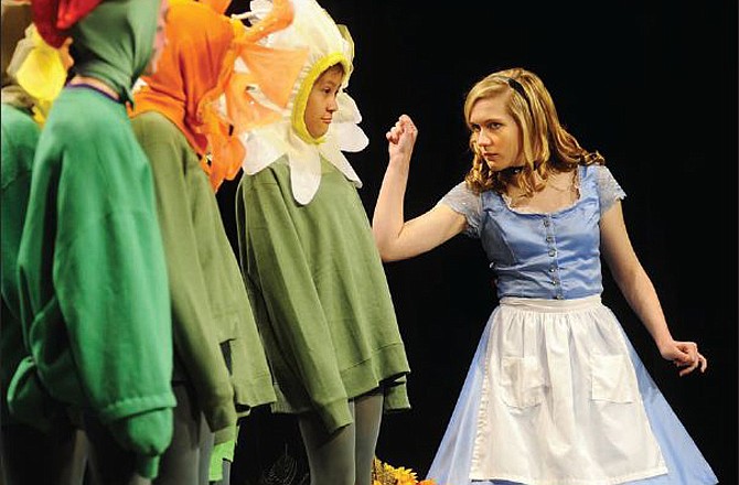 Alice, played by Erin Hoerchler, threatens to pick the daisies if they don't hold their tongues while rehearsing the "Garden of Live Flowers" scene for the Helias High School drama department's presentation of Alice in Wonderland at the Miller Performing Arts Center in Jefferson City.