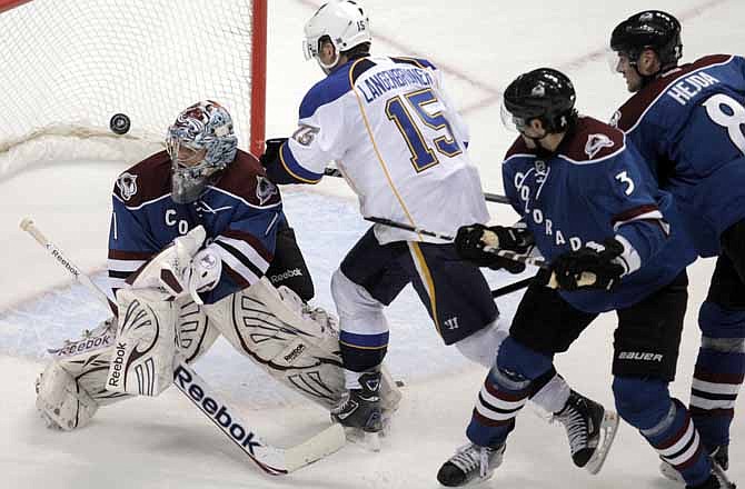 Colorado Avalanche goalie Semyon Varlamov (1), of Russia, deflects the puck as St. Louis Blues right wing Jamie Langenbrunner (15) skates into him in the second period of a NHL hockey game in Denver on Friday, Dec. 2, 2011. Avalanche defensemen Ryan O'Byrne (3) and Jan Hejda watch the play. Langenbrunner was penalized for goalie interference.