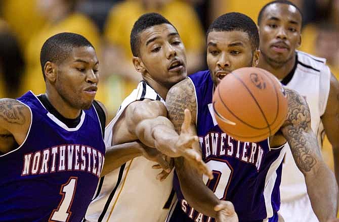 Northwestern State's Demetrice Jacobs, left, and teammate Shamir Davis (0) fight off Missouri's Phil Pressey, center, and Marcus Denmon, right, for a loose ball during the second half of an NCAA college basketball game on Friday, Dec. 2, 2011, in Columbia. Mo. Missouri won the game 90-56.