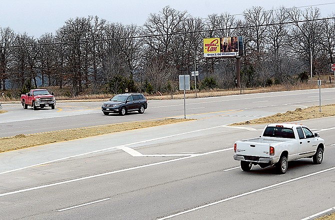 A pickup waits Monday for traffic to clear the J-turn intersection on U.S. 54 at Honey Creek Road.