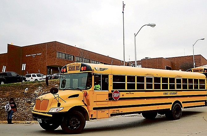 Buses leave the Jefferson City High School campus after school dismissed for the day Monday afternoon.