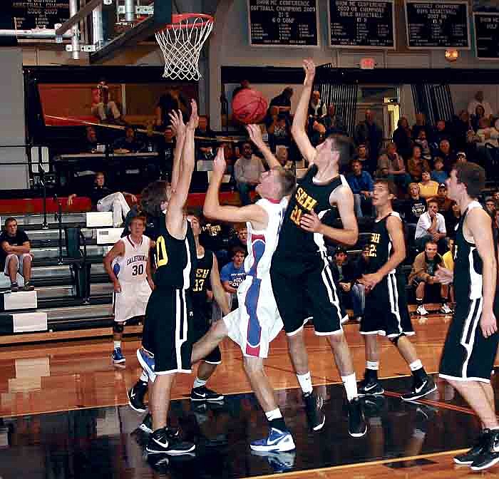 California's Phillip Longan, center, puts up a shot during the Pintos' game against St. Elizabeth Nov. 29.