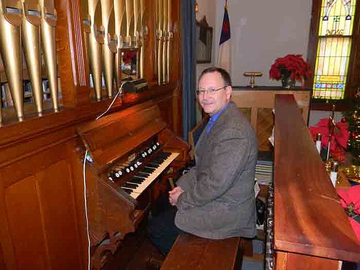 Sam Lucas, director of music at Clinton United Methodist Church, with the Hinners Organ he played at Grace United Methodist, Jamestown, Sunday, Dec. 4.