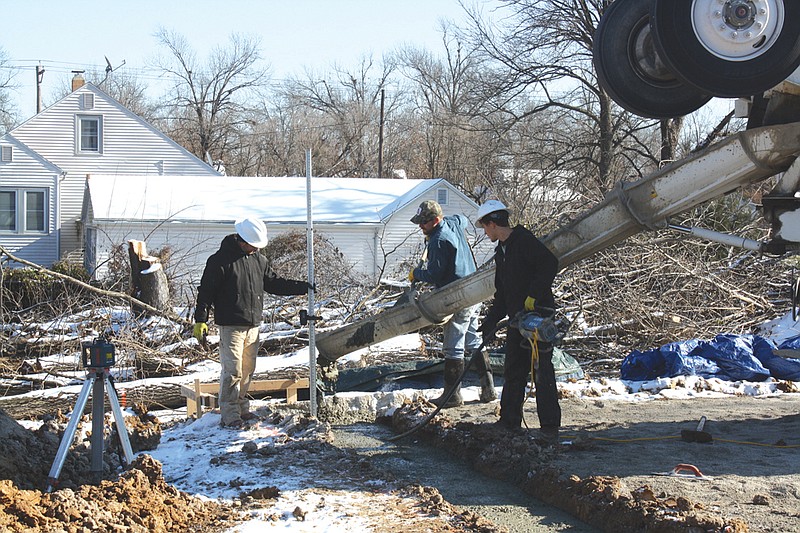 Workers from Schlacks Construction and MO-Con, Inc., pour concrete footings Wednesday for a new Xpress Mart being built on the corner of Bluff and 13th streets.