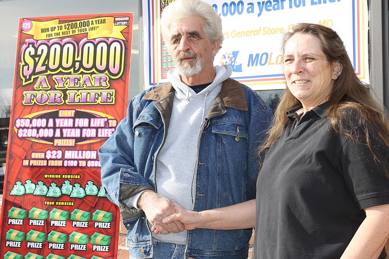 Spencer Coffman of Fulton is congratulated Thursday for winning $750,000 in a Missouri Lottery scratchers game by Annette Holtmeyer, the employee at Casey's General Store at 1301 Business 54 South in Fulton who sold Coffman the winning ticket.