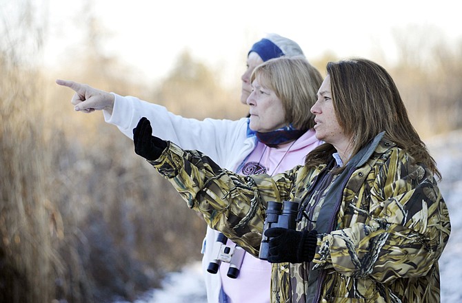 Department of Conservation naturalist Trana Madsen, right, directs Dora Ransdell, Jefferson City, center, and Carol Craig, Sedalia, to where she spotted a Northern flicker woodpecker Thursday morning, Dec. 8, 2011, at Runge Nature Center in Jefferson City.