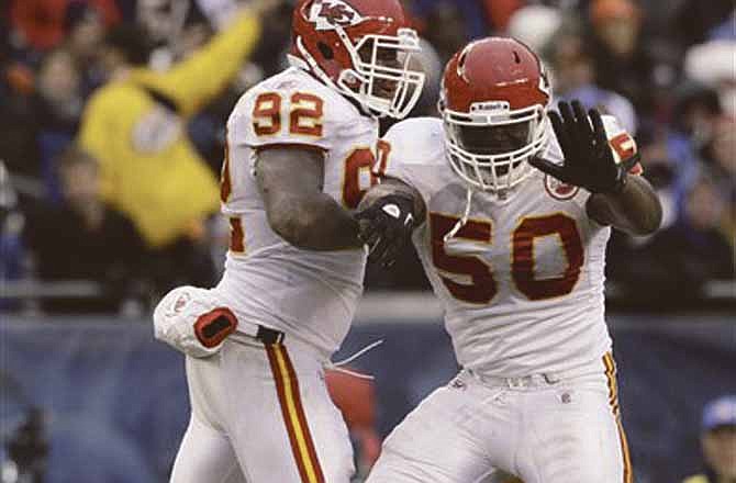 Chiefs linebacker Justin Houston (50) celebrates a sack with teammate Wallace Gilberry against the Bears on Sunday in Chicago.