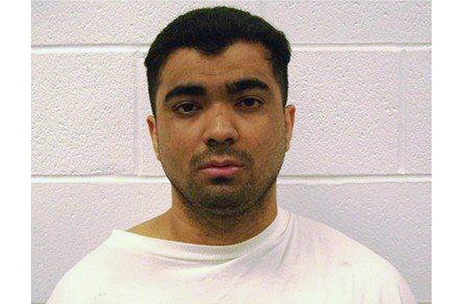 This photo provided Dec. 7, 2011, by the Arkansas Department of Correction shows Erickson Dimas-Martinez who was convicted in 2010 in the slaying of Derrick Jefferson. The Arkansas Supreme Court has tossed out the death row inmate's murder conviction, finding misconduct among jurors who slept and tweeted during the proceedings. (Photo via AP)