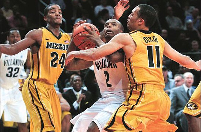 Missouri teammates Kim English (24) and Michael Dixon (11) defend Villanova's Maalik Wayns during Tuesday night's game in New York.