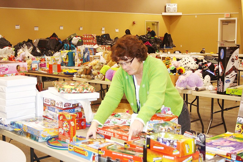 Judy Kelly with Fulton State Hospital selects a few toys from those donated through one of several local drives for SERVE to help round out the hospital's gift giving efforts for the Adopt-a-Family program. 