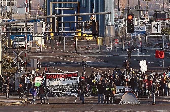 Protesters set up a picket line at a Port of Portland terminal Monday in Portland, Ore., as part of a West Coast "day of action." Anti-Wall Street protesters along the West Coast joined an effort Monday to blockade some of the nation's busiest docks, with the idea that if they cut off the ports, they cut into corporate profits.