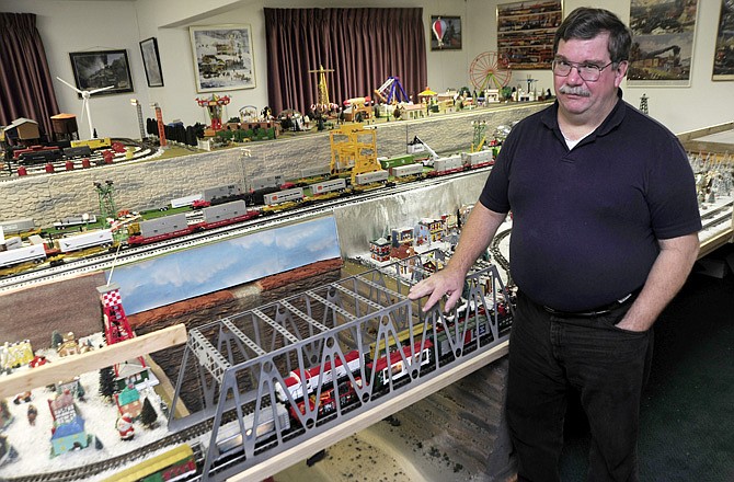 Arthur Kristofik stands by his train at the America's Best Value Inn Hotel in Holts Summit. Kristofik said this is the 10th year for the Christmas train exhibit.