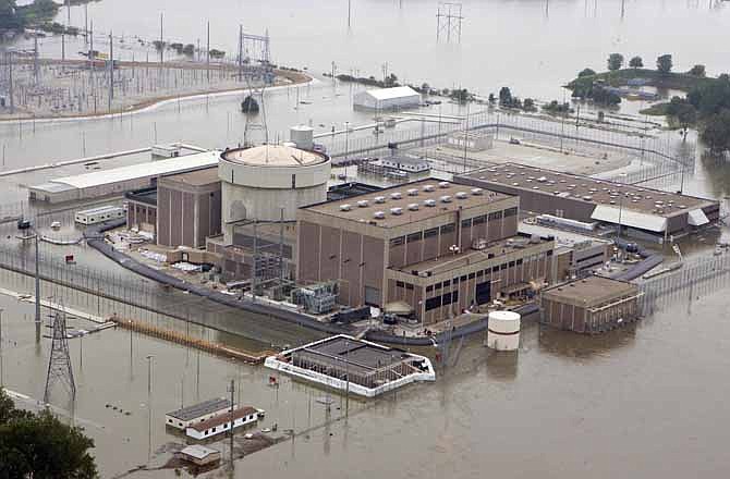 In this June 14, 2011 file photo, the Fort Calhoun nuclear power plant is surrounded by the rising waters from the Missouri River in Fort Calhoun, Neb. 