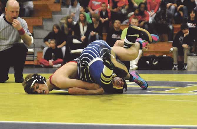 Jefferson City's Cole Baumgartner takes down Helias' Ryan Mankin during their match at 132 pounds Wednesday night at Rackers Fieldhouse. The Jays won the dual 67-6.

