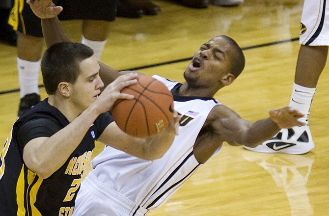 Kennesaw State's Mirza Sabic (left) hits Missouri's Kim English with an elbow during the first half of Thursday's game in Columbia. Sabic was called for flagrant foul on the play.