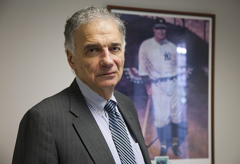Ralph Nader stands next to a poster of Lou Gehrig in his office Tuesday in Washington. Over a five-decade career in America's consumer movement, Nader has fought against the auto industry over safety and has targeted businesses he blamed for water pollution, nursing home fraud, and more. Now he's taking on sports.