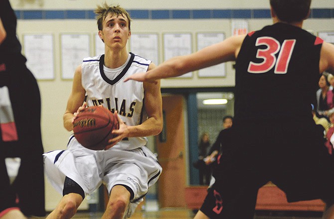 Helias senior guard Deion Hughes eyes the basket during the Crusaders' win against on Branson Friday night at Rackers Fieldhouse. 