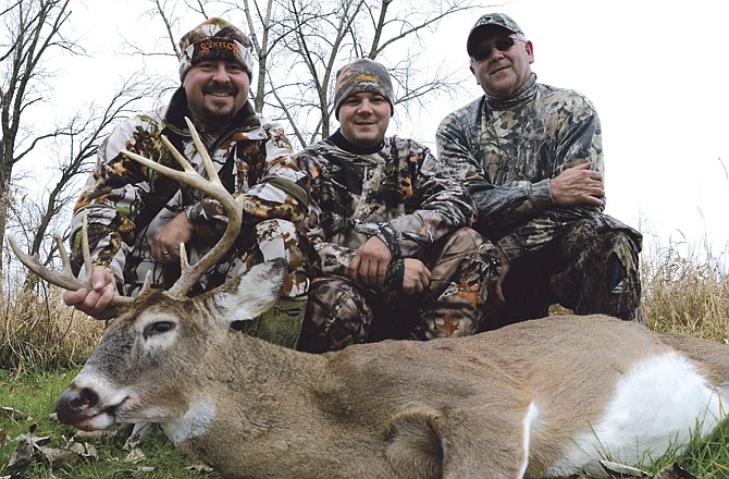 (From left) Brandon Butler, Jimmy Rowan and Tom Butler display a recent deer legally taken. 