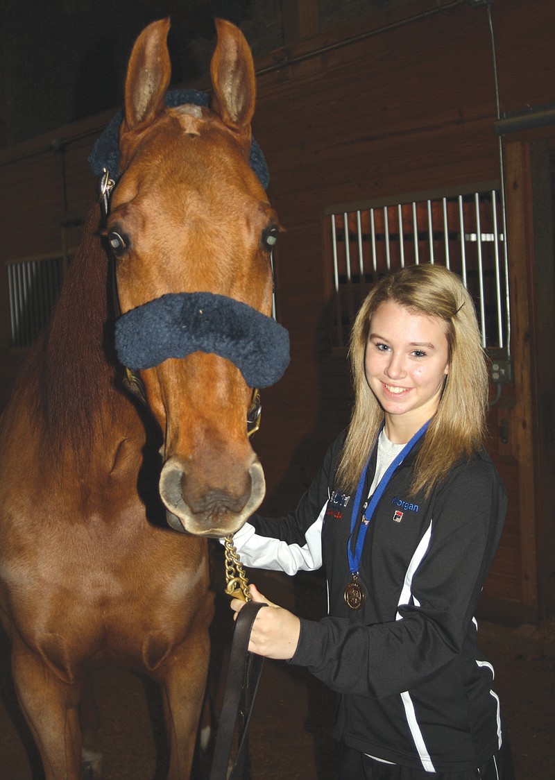 Morgan Brison stands with her favorite show horse, Waldo, at her parents' stables in New Bloomfield. She sports the gold medal she won earlier this month at the International Saddle Seat Invitational in South Africa.