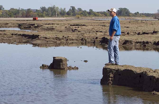 In this Sept. 19, 2011, file photo Rob Chatt sees for the first time the extent of the soil erosion caused to his family's corn fields by the streaming flood waters of the Missouri River, near Tekamah, Neb.