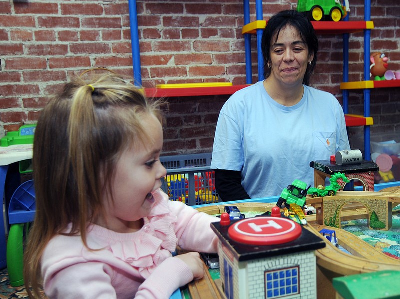 Alisha Courtney, right, watches her daughter, Amelia Courtney, 3, play with toys Tuesday at the Lafayette House in Joplin. When the deadly Joplin tornado destroyed her father's home, Alisha Courtney had no place to go except back to her abusive boyfriend, whose regular beatings she'd fled just weeks before.