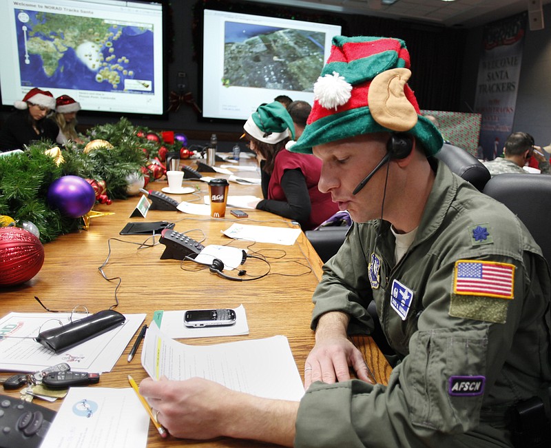 Air Force Lt. Col. David Hanson, of Chicago, takes a phone call on Dec. 24, 2010, from a child in Florida at the Santa Tracking Operations Center at Peterson Air Force Base near Colorado Springs, Colo. Officials at NORAD are expecting a banner year for kids calling in to track Santa.