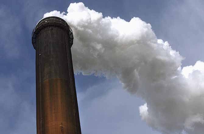 In this photo taken Nov. 18, 2011, steam and effluent is dispersed through the top of one of the smokestacks at the city of Springfield's coal-fired power station complex in Sangamon County, Illinois. Most Illinois utilities won't miss a beat under new U.S. Environmental Protection Agency rules requiring coal-fired power plants to control mercury emissions for the first time. In fact, the state already is way ahead. 