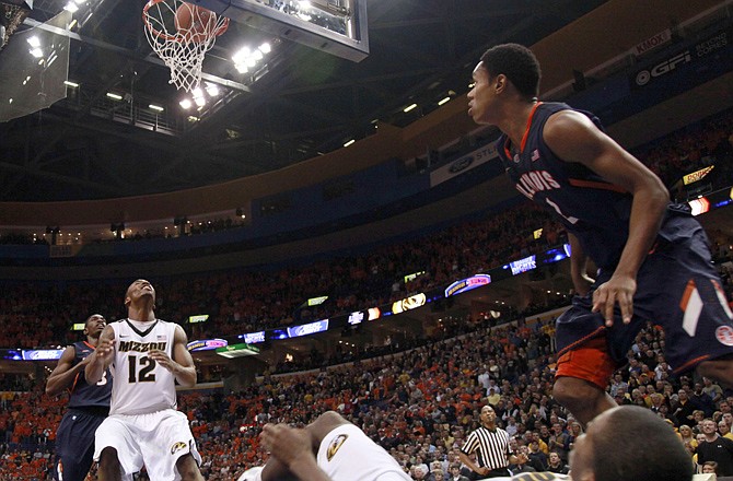 Missouri's Kim English (bottom) watches as his shot falls after he was fouled by Joseph Bertrand of Illinois (right) during the second half of Thursday night's game in St. Louis. Marcus Denmon of Missouri and Brandon Paul of Illinois look on.