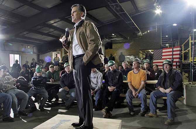 In this Monday, Dec. 12, 2011 file photo, Republican presidential candidate, former Massachusetts Gov. Mitt Romney speaks during a campaign stop with mill workers at the Madison Lumber Mill in Madison, N.H. 