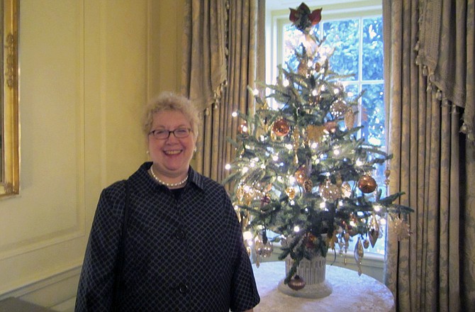 In this Wednesday Nov. 30, 2011 photo provided by Kathy Gastinger, Gastinger poses in the White House in Washington D.C., after she and her sister, Paula Krajcir, helped decorate the White House for the 2011 Christmas season.