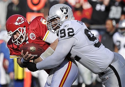 Kansas City Chiefs quarterback Kyle Orton (8) is sacked by Oakland Raiders defensive tackle Richard Seymour (92) during the first half of an NFL football game at Arrowhead Stadium in Kansas City, Mo., Saturday, Dec. 24, 2011. 