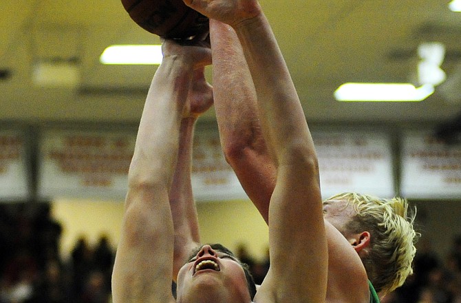 Hale Hentges of Helias and Kellen Brondel of Blair Oaks battle for a rebound during Wednesday night's game in the Mike Kehoe Great 8 Classic at Fleming Fieldhouse.