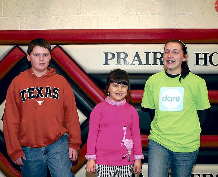 Selected as the Prairie Home School Students of the Month for Dec., from left, are Ben Stock, eighth grade; Caroline Rhode, kindergarten; and sophomore Kohlie Stock.