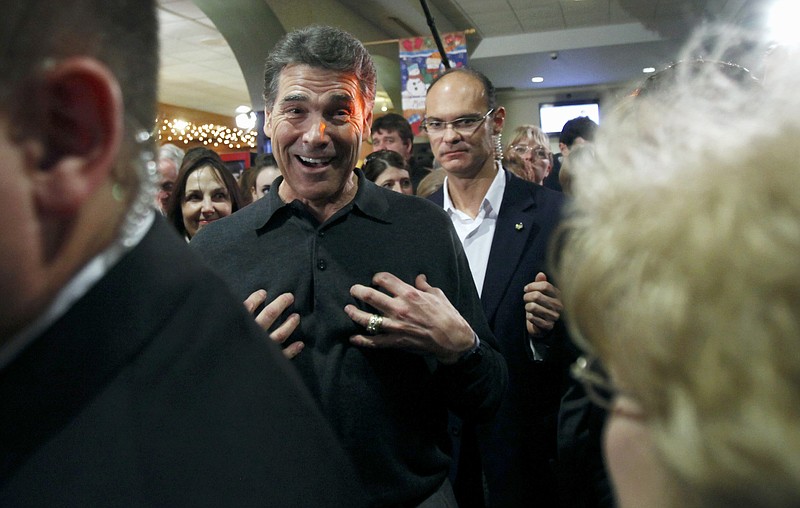 Republican presidential candidate, Texas Gov. Rick Perry greets local residents during a campaign stop Thursday at the Blue Strawberry Coffee Company in Cedar Rapids, Iowa.