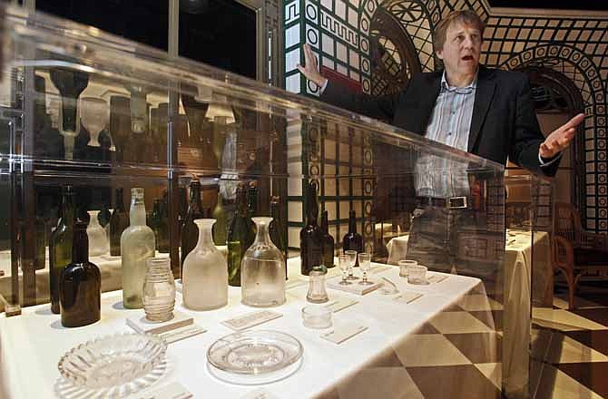 John Zaller, creative director of Premier Exhibitions, discusses objects from the Titanic's Verandah Cafe on display in the "Titanic: The Artifact Exhibition" at the Discovery Times Square Exposition in New York, in this June 24, 2009 file photo. The owner of the largest trove of artifacts salvaged from the Titanic is putting the vast collection up for auction as a single lot in 2012, the 100th anniversary of the world's most famous shipwreck.