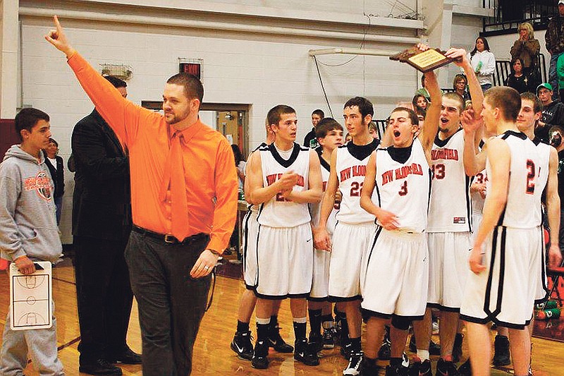 Former New Bloomfield boys basketball coach Tyler Clark celebrates with his team after capturing the Class 2, District 5 championship with a 58-52 win over Silex on March 5, 2011. Clark officially stepped down from his post on Wednesday.