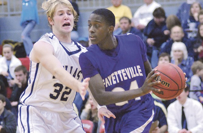 Aaron Vossen of Helias applies defensive pressure on Jawan Smith of Fayetteville during Friday night's game in the Mike Kehoe Great 8 Classic at Fleming Fieldhouse.