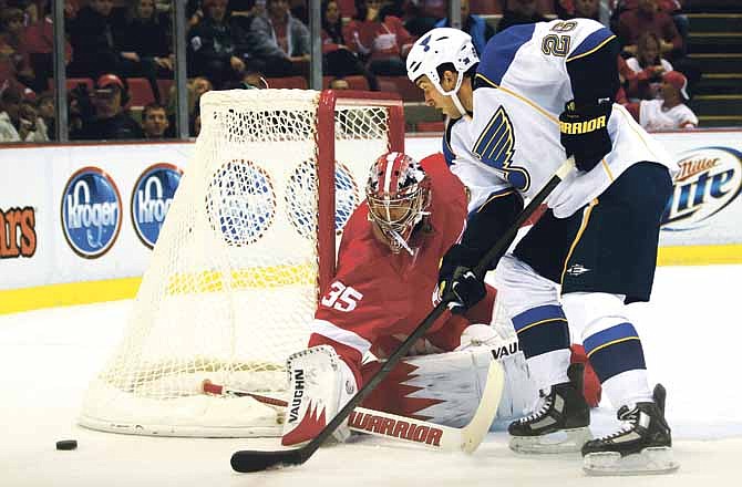 Detroit Red Wings goalie Jimmy Howard (35) makes a save on a shot by St. Louis Blues right wing B.J. Crombeen (26) in the first period of an NHL hockey game in Detroit, Saturday, Dec. 31, 2011.