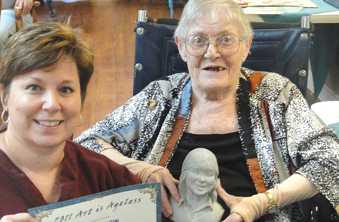 Tammy Gillespie, of Fulton, shows her mother's award during the 2011 Art is Ageless art competition. The late Jean Makela won Best of Show for her sculpture, and it was featured in the Presbyterian Manors of Mid-America's 2012 Art is Ageless calendar. Entries for this year's show are due by Jan. 31.  