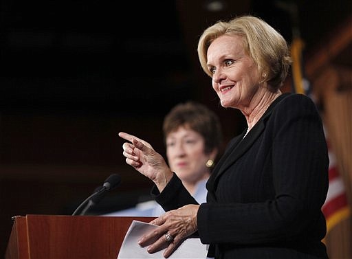 In this file photo from Dec. 6, 2011, Sen. Claire McCaskill, D-Mo., right, accompanied by Sen. Susan Collins R-Maine, gestures during a news conference on Capitol Hill in Washington.