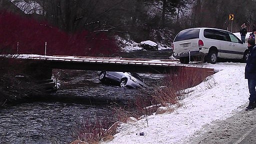 In this Saturday, Dec. 31, 2011 photo provided by rescuer Chris Willden, a car is submerged in the icy Logan River near Logan, Utah, after as many as 10 passersby jumped in to flip it back over and rescue three young children trapped inside. The car plunged 10 feet down an embankment on U.S. 89 in icy conditions and one rescuer used a handgun to shoot out the window to get the children out. A boy and girl were both revived and are in fair condition, while the driver and a second 9-year-old girl were not injured. 